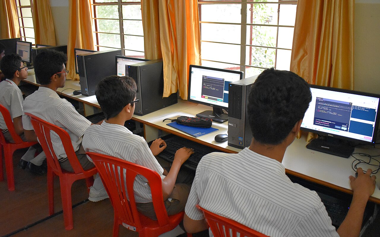 Indian school students learning to write code together in a school computer lab